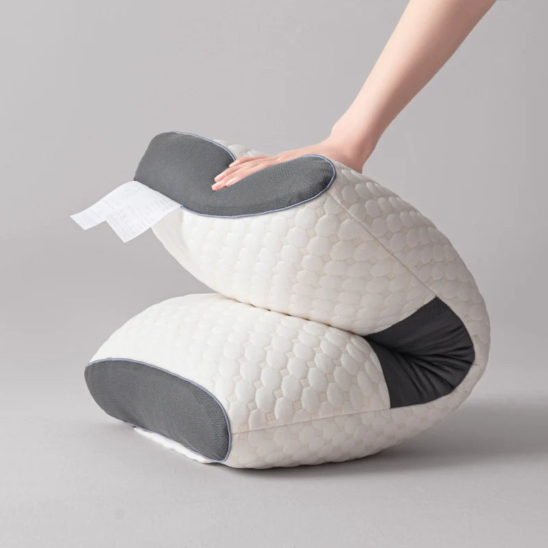 : Ergonomic neck pillow on a neatly made bed for a pain-free sleep setup – HouseComfort